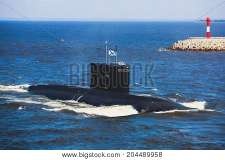 A line of modern russian military submarine cruisers in the row, northern fleet and baltic sea fleet in the open sea, submarine