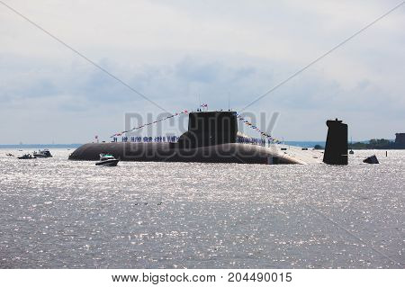 A line of modern russian military submarine cruisers in the row, northern fleet and baltic sea fleet in the open sea, submarine