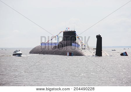 A line of modern russian military submarine cruisers in the row, northern fleet and baltic sea fleet in the open sea, submarine