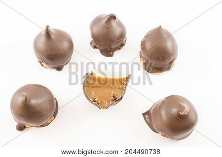 Bow of whole milk confectionery cones and one cut in half in half. White background.