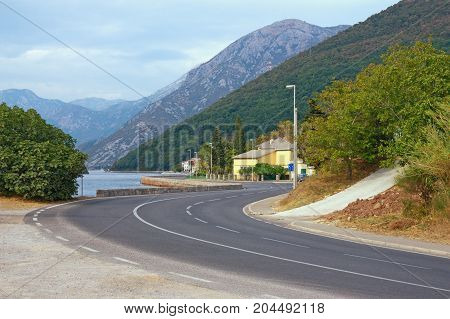 Traveling in the Balkans. Montenegro the road along the Bay of Kotor near Lepetane village and ferry