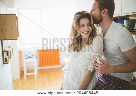 Romantic couple in love speding time together in kitchen