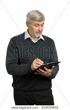 Confident senior supervisor writing on clipboard. Handsome mature man writing something using clipboard.