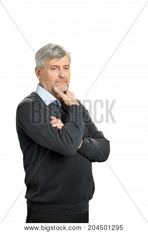 Thoughtful mature man on white background. Thoughtful senior man in formalwear holding hand on chin and looking away, white background. Pensive elderly man isolated on white background.
