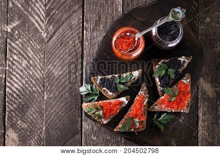 Red And Black Caviar In Small Silver Spoon On A Wood Background With Black Bread ,food Concept