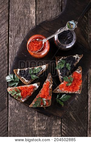 Red And Black Caviar In Small Silver Spoon On A Wood Background With Black Bread ,food Concept