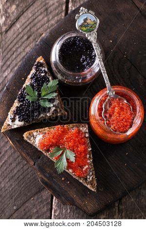 Red And Black Caviar In Small Silver Spoon On A Wood Background With Black Bread ,food Concept