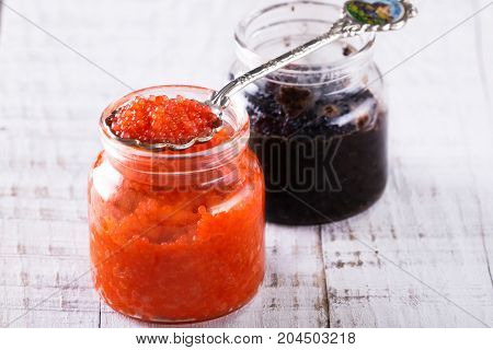Red And Black Caviar In Small Silver Spoon On A Wood Background With Black Bread ,food Concept