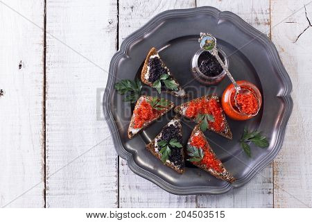 Red And Black Caviar In Small Silver Spoon On A Wood Background With Black Bread ,food Concept