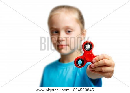 Little girl play with modern finger spinner..New spinning device.Play balance game with popular rotating gadget on bearings