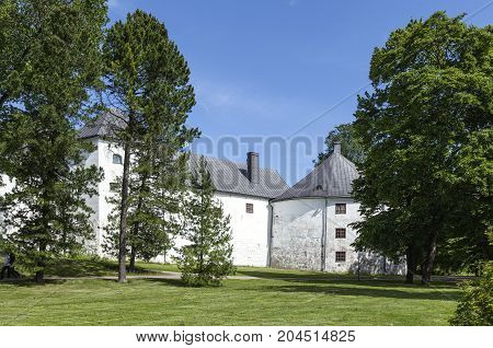 TURKU, FINLAND ON JUNE 30. Outdoor view of the Turku Medieval Castle from the 13th century on June 30, 2017 in Turku, Finland. Classical stone building. Unidentified people. Editorial use.