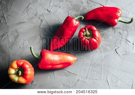 Bell Sweet Red Peppers On Concrete