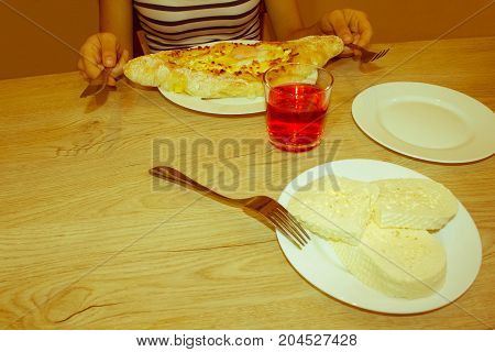 Adjarian Khachapuri - georgian cheese pie with egg. Adjarian khachapuri on a on a plate. Open pie with cheese in the shape of the boat - Retro color