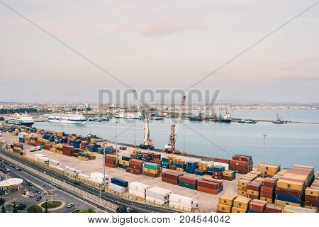 ALBANIA DURRES - September 22 2015: view from above to the port of Durres in the Adriatic Sea. A platform for containers surrounded by tower cranes for unloading. In the port there are tourist cruise liners and tankers for cargo transportation.