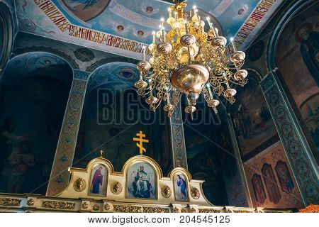Dnipro Ukraine - August 06 2017: Church of St. Nicholas large gold or bronze chandelier in the temple or cathedral big bronze with handelier in the church orthodox church inside