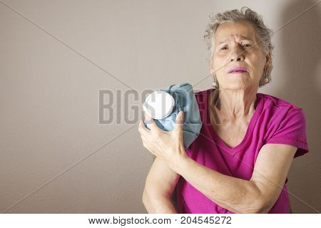 Ice pack on older woman arm to relieve pain