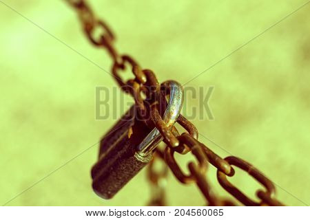 Old black padlock on a rusty chain. Illustration of force the inviolability strength durability