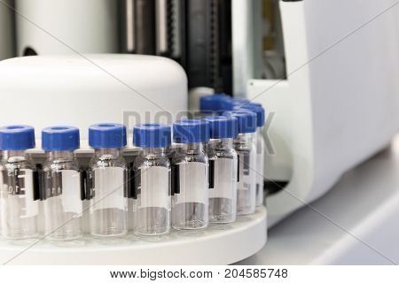 A cassette with glass test tubes, a fragment of gas chromatograph equipment. Research equipment.