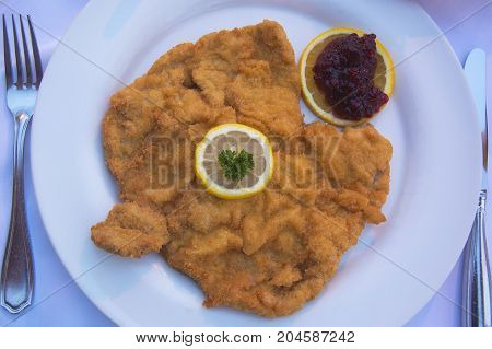 Authentic Schnitzel Wiener Art or Wiener Schnitzel vom Schwein (Pork) Served at as Restaurant in Innsbruck, Austria