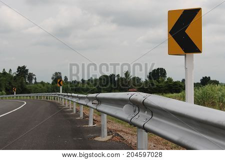 Roads with dangerous bends ahead and warning signs to drive carefully.