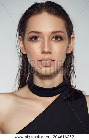 Portrait of beautyful woman in black dress isolated wet hair