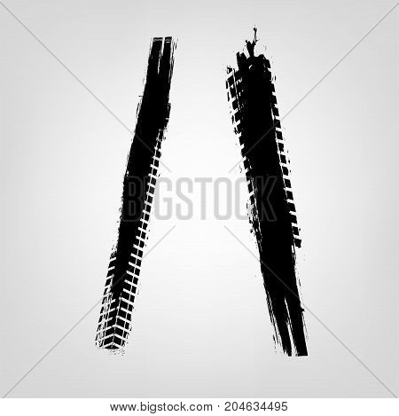Grunge tire glyphs. Slash and backslash. Unique off road isolated lettering in a black colour on a light grey background. Vector illustration. Creative typography collection.