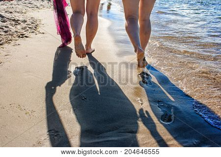 footprints in the wet sand of the beach on sunny summer day