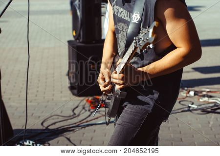 Novokuzneck Russia 27.06.2017: closeup of teenager playing electric guitar in the street