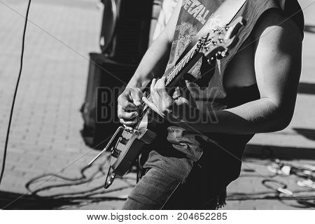 Novokuzneck Russia 27.06.2017: closeup of teenager playing electric guitar in the street