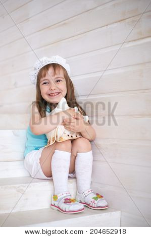 Young beautiful  girl white seashell indoors. White