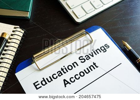 Education savings account ESA form in a clipboard.