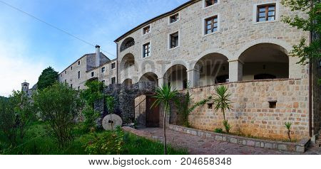 BUDVA MONTENEGRO - SEPTEMBER 7 2017: Unknown monk is on territory of monastery Podmaine (Podostrog) Budva Montenegro
