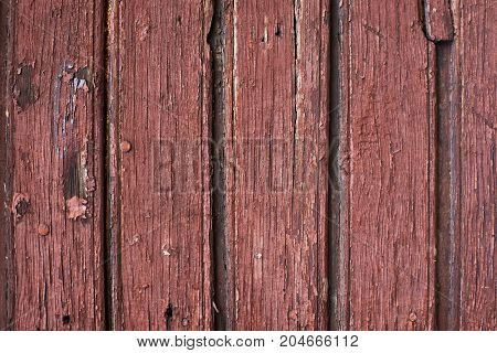Old wood with red paint. Vertical row.