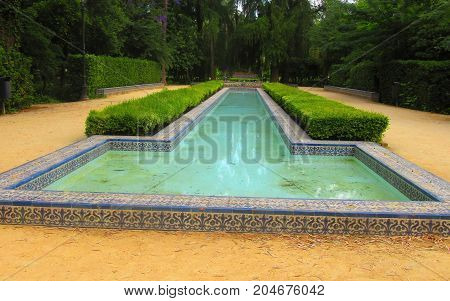 a magnificent foutain garden of la cruz ( seville spain )