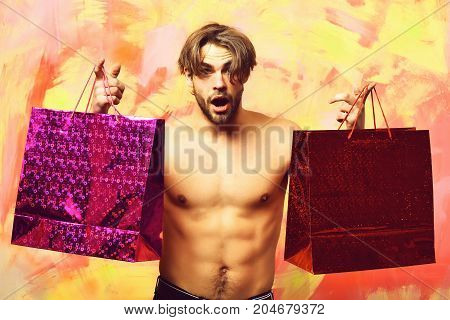 Caucasian Bearded Sexy Macho Man Holding Red Packages Or Bags