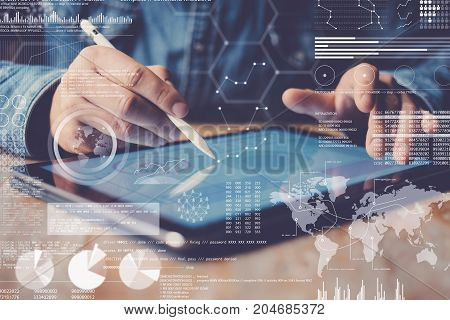 Concept of digital diagram, graph interfaces, virtual display, connections icon.Man using stylus pencil on display of contemporary electronic tablet.Blurred background. Horizontal