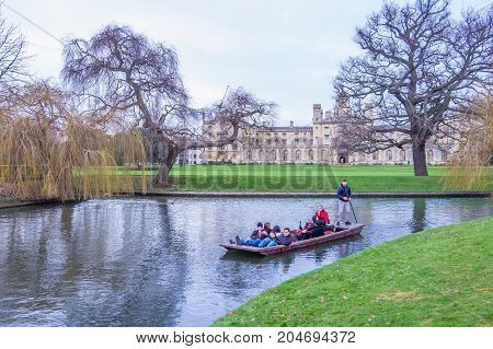Oxford UK - December 21 2016 : Unidentified people in a boat over the river Cherwell near university of Oxford botanic gardens Oxford United Kingdom.
