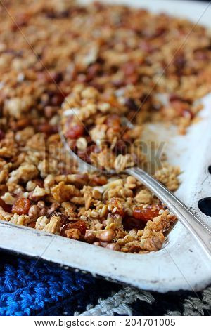 Home granola on a white baking sheet. Rustic style, selective focus.