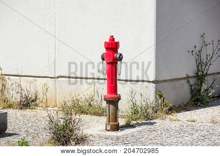 Old red fire hydrant in the street. Fire hidrant for emergency fire access .