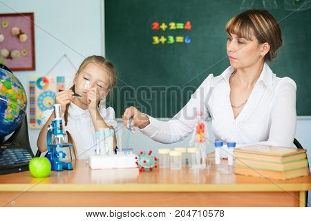 Cute Schoolgirl And Her Teacher In A Classroom