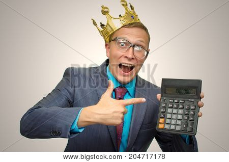 Funny mad accountant with calculator in hands and golden crown above his head. Submission of the annual report. Finacial results. Stock market trader profit. Winner.