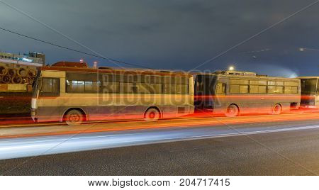 abandoned transport metropolis, traffic and blurry lights of cars on the highway and multiband dense road traffic at night in Moscow