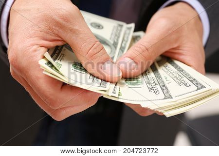 Man Hold In Arm Pack Of Hundred Dollar Bills