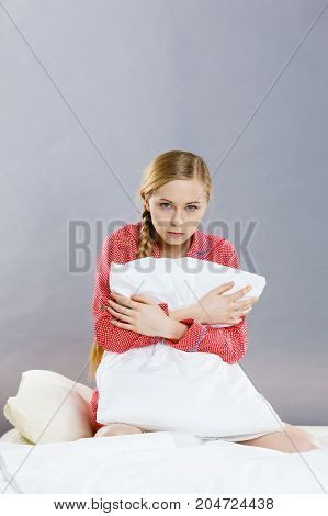 Sad Depressed Girl In Bed Gripping Pillow