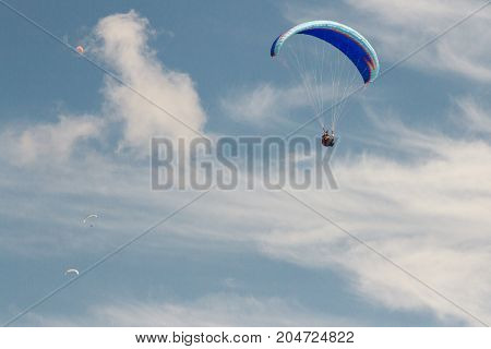 A para-glider up in the sky during a fly surrounded by the clouds