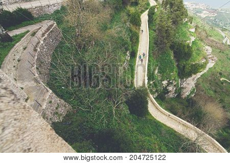 Three guys walking on a trail in a mountain named Erice province of Trapani