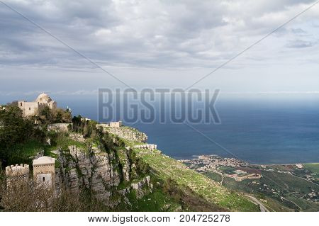 View of two old churches situated on Erice mountain with the mediterranean sea in the background