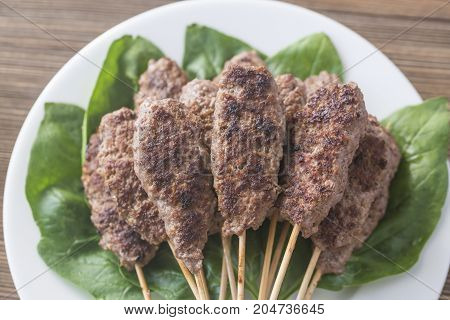 Beef cabobs on the fresh spinach leaves