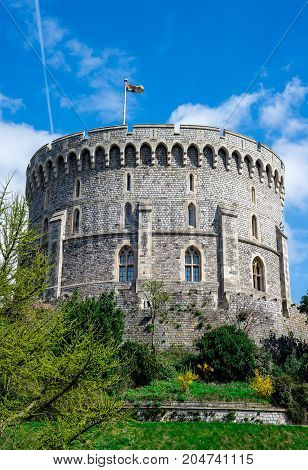 Windsor, England, April 2017: Round Tower with a raised flag in Windsor Castle county of Berkshire England
