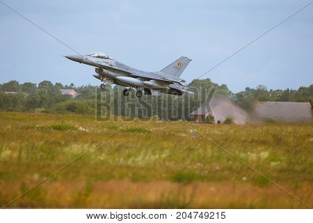 Schleswig - Jagel Germany - June 19 2014:Belgium - Air Force F-16 Fighting Falcon board number FA-109 is takeoff for background of field and skyline the airbase during NATO Tiger Meet 2014